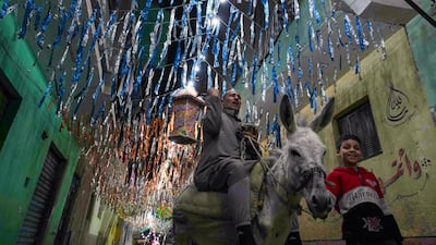 Fifty-five-year-old "musaharati," or "dawn caller" Essam Sayed, rides his donkey to wake people up for a meal before sunrise, during Ramadan, in the Arab Ghoneim district of Helwan on the southern outskirts of Cairo. AP