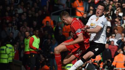 Liverpool's Jordan Henderson, left, clashes with Manchester United defender Phil Jones on Sunday during their Premier League contest. Paul Ellis / AFP
