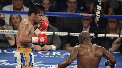 Manny Pacquiao (L) of the Philippines watches Timothy Bradley of the USA after knocking him down in the ninth round during their WBO International Welterweight bout at the MGM Grand Garden Arena in Las Vegas, Nevada, USA, 09 April 2016. Pacquiao won with a unanimous decision. EPA/MIKE NELSON