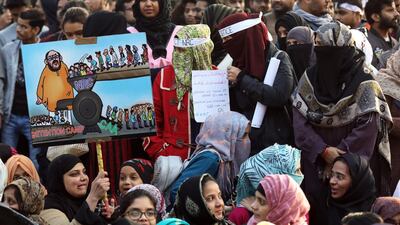 Indian activists hold placards and shout slogans as they protest against Citizen Amendment Act(CAA) outside Jamia Millia Islamia University, in New Delhi. EPA