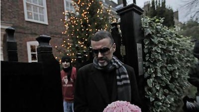 The British singer George Michael in front of his house in north London on Friday. He is recovering from a life-threatening bout with pneumonia that kept him in a Vienna hospital for a month. Lefteris Pitarakis / AP Photo