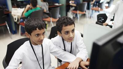 Mohamed Alowais, 8, and his brother Nasir, 9, at the course at Hamdan bin Mohammed Smart University in Dubai. Their father says ‘computer science is a tool for the future’. Anna Nielsen for The National