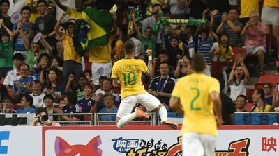 Neymar celebrates the first of his four goals for Brazil in a 4-0 friendly win over Japan on Tuesday night in Singapore. Roslan Rahman / AFP / October 14, 2014
