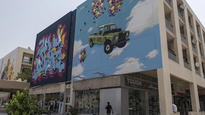 Eight street artists have helped give the area a facelift by painting 24 huge murals on the side of 12 apartment buildings and shops around the Karama shopping complex. Antonie Robertson / The National