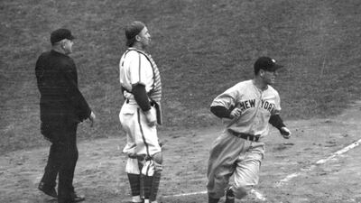 In this October 5, 1938 file photo, the New York Yankees' Lou Gehrig scores the first run of the 1938 World Series against the Chicago Cubs as he crosses home plate in the second inning of Game 1 at Wrigley Field in Chicago. A dozen years before Babe Ruth’s famed ‘Called Shot,’ teammate Lou Gehrig hit an equally dramatic homer. Gehrig was 17 when his high school team traveled to Chicago to take on a Chicago team. In the bottom of the ninth, with two outs and his team down 8-6, Gehrig hit a ball over the wall and onto Sheffield Avenue to win the game. AP Photo