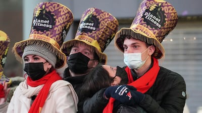 Masked revellers enjoy New Year's Eve celebrations in Times Square, New York City. Reuters