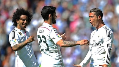Cristiano Ronaldo, right, celebrates his opener with Marcelo, left, and Isco, centre. Denis Doyle / Getty Images