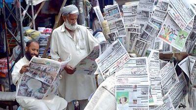 Pakistani men in Rawalpindi read the newspapers a day after the country’s landmark general elections.