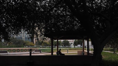 A man sits in Lake Park in Abu Dhabi as the city is overcast again this week. Delores Johnson / The National