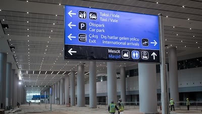 Airport employees are seen working in the arrivals hall. Getty Images