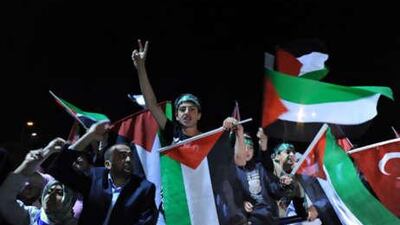 Demonstrators chant slogans and wave Palestinian flags as they welcome Turkish activists expelled from Israel, at Istanbul's airport.