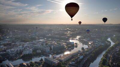 Hot air balloons float above Bristol's historic harbourside. Getty Images