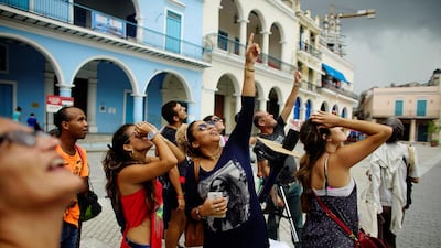 People look towards the sky as enthusiasts gather in Old Havana for the partial solar eclipse in Cuba. Alexandre Meneghini / Reuters