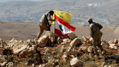 Hezbollah fighters put Lebanese and Hezbollah flags at Juroud Arsal, Syria-Lebanon border, July 25, 2017. Reuters