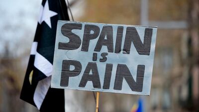 A protester holds a sign reading "Spain is pain" during a demonstration in Barcelona, Spain, on March 25, 2018. Josep Lago / AFP Photo