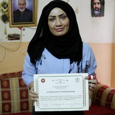 Iraqi female wrestler Alia Hussein poses with her certificate of appreciation awarded by the Lebanese Wrestling Federation, after winning the silver medal during the world championships held in Lebanon. AFP