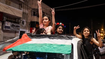 Gaza residents and supporters of the Palestinian Islamic Jihad militant group celebrate on a street in Gaza city, after a ceasefire agreement was reached with Israel on Saturday. All photos: AFP