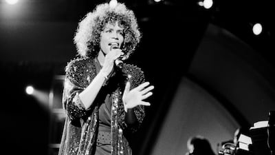 Whitney Houston performs onstage at Jones Beach, New York in 1982. Getty Images.