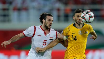 Australia's Apostolos Giannou, right, fights for the ball with Syria's Omro Midani. AP Photo