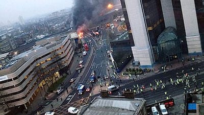 Smoke pours from the burning debris of a helicopter which crashed in the Vauxhall area of London today.