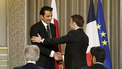 Mr Macron welcomes Sheikh Tamim to the reception. EPA