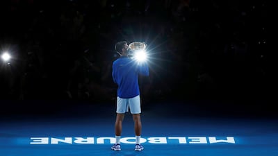 Novak Djokovic poses with the championship trophy. Reuters