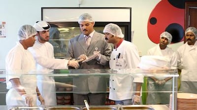 January 12, 2011 / Abu Dhabi / (Rich-Joseph Facun / The National) Ibrahim A. Al Ali , (CQ), an Inspector with the Abu Dhabi Food Control Authority, second from left, and Mansour A. Abd El Latif (CQ), center, a Senior Inspector with the Abu Dhabi Food Control Authority inspect the school cafeteria of the Emirates National School as part of an ongoing campaign, Wednesday, January 12, 2011 in Abu Dhabi.
