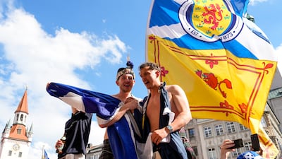 Scotland fans cheer in Munich's Marienplatz square. AP
