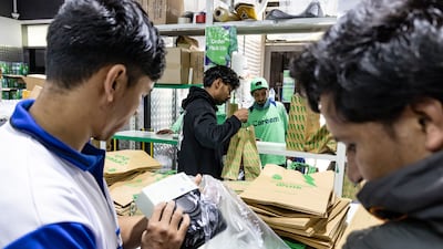 Staff pack orders at the Careem base in Al Barsha for delivery to the public. All photos: Antonie Robertson / The National