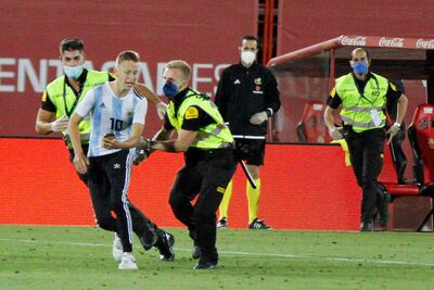 A supporter invades the pitch in what was supposed to be a game played behind closed doors. AP