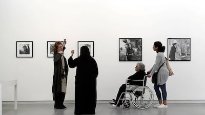 Visitors take in the work of Latif Al Ani during the photographer's exhibition at Sharjah Art Foundation in Sharjah. Pawan Singh / The National