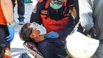 A man receives treatment after being rescued from a damaged building in New Taipei City. AFP