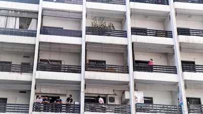 Residents on their balconies inside the lockdown area on Tuesday. They began 14 days of isolation on Tuesday