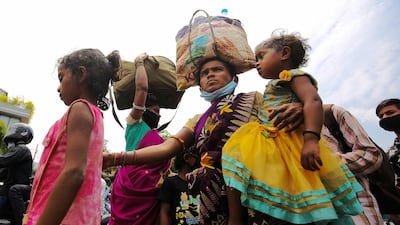 Indian migrant labourers arrive with their children to get train tickets at palace grounds, Benguluru, India, May 23. Jagadeesh NV/ EPA