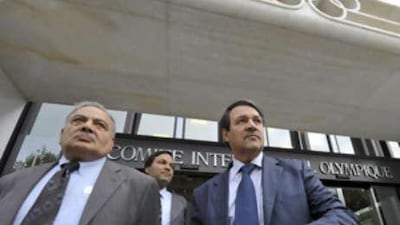 Basil Abdul Mahdi, left, a senior adviser from the Iraqi ministry of youth and the Iraqi government spokesman Ali al-Dabbagh arrive for a meeting to try to salvage Iraq's participation in the upcoming Beijing Olympics.