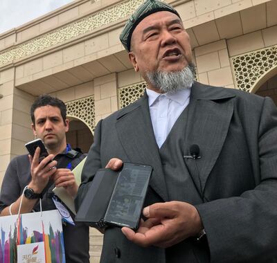 Abudulrekep Tumniaz, dean of the Xinjiang Islamic Institute addresses journalists outside the institute’s new campus in Urumqi
