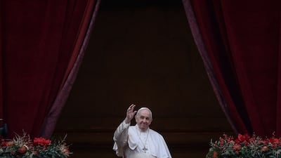 Pope Francis waves to the gathered faithful following his Christmas blessing in St Peter's Square at the Vatican. AFP