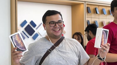 An iPhone fan purchasing 2 phones at the launch of iPhone XS at Apple store in Dubai Mall.