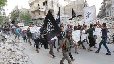 Supporters of Jabhat Al Nusra - Al Qaeda's Syria affiliate - hold placards denouncing President Bashar Al Assad and Arab states that have joined anti-ISIL campaign, as they demonstrate in the northern city of Alepppo on September 24, 2014. Zein Al Rifai/AFP Photo