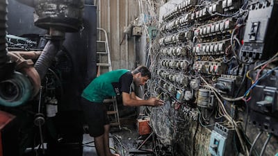 A technician at an electric switchboard that connects homes to privately owned electricity generators in a suburb of Baghdad, where the national electricity grid is experiencing failures during the severe heat wave.