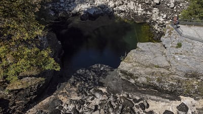 People look at the dried-up Saut du Doubs waterfall in Les Brenets, Switzerland. Reuters
