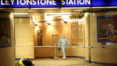 Police officers investigate a crime scene at Leytonstone underground station in east London. Neil Hall / Reuters