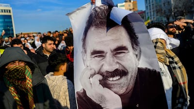 Supporters of Abdullah Ocalan hold up a poster depicting the jailed leader of the Kurdistan Workers' Party (PKK) in Diyarbakir, south-eastern Turkey, in February 2025. AFP