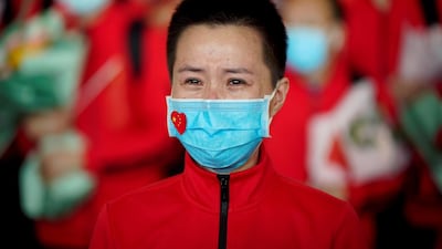 A member of a medical team weeps at the Wuhan Tianhe International Airport after travel restrictions were lifted. Reuters