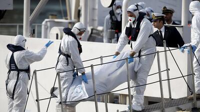 Italian coastguard personnel carry the body of a dead migrant off their ship in Valletta's Grand Harbour on April 20, 2015. More than 800 migrants are believed to have died after their boat capsized in the Mediterranean the day before. Darrin Zammit Lupi/Reuters