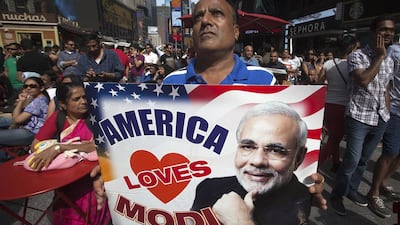 A man holding up a sign in support of Indian prime minister Narendra Modi ahead of his speech that was broadcast on a giant screens in New York's TImes Square on September 28, 2014. Carlo Allegri/Reuters