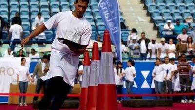 Competitors take part in the annual Waiter Race at Zayed Sports City in Abu Dhabi. Christopher Pike / The National