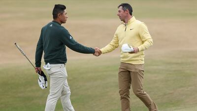 Northern Ireland's Rory McIlroy, right, and Collin Morikawa of the US shake hands after the first round of the Open Championship on the Old Course at St Andrew on Thursday, July 14, 2022. McIlroy shot a round of 66 to finish on six under par. AP