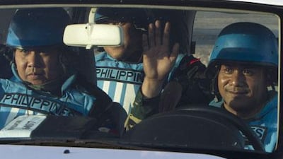 UN peacekeepers of the United Nations Disengagement Observer Force cross a checkpoint between Israel and Syria in the occpupied Golan Heights on Saturday. A group of 21 Filipino UN peacekeepers seized by Syrian rebels on the Golan were freed on Saturday. AFP
