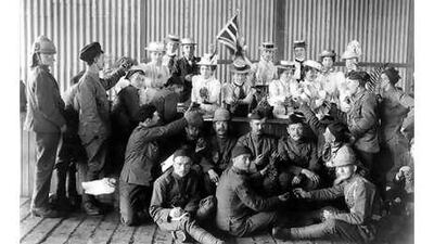 A group of soldiers from the Boer War being given tea and grapes in Cape Town, South Africa.